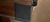 Brunswick Billiards Brunswick Canton Slate Pool Table, Black Forest and Rustic Grey Finish, close-up of the corner showcasing the wood grain and textured black frame.