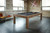 Brunswick Billiards Brunswick Sanibel Slate Pool Table in Rustic Grey, modern game room with large windows, brick and wood walls, and contemporary decor.