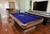 Brunswick Billiards Brunswick Centennial Slate Pool Table - Rosewood Finish, Chrome Accents, in a game room with hardwood floors and a wall-mounted TV.