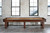 Brunswick Billiards Brunswick Canton Shuffleboard Table, 12' or 14', in Black Forest Finish, placed in front of large windows and a brick wall.