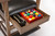 Brunswick Billiards Centennial Player's Chair, storage drawer filled with billiard balls, and cleaning brush inside the drawer.