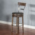 Sawyer Twain Bobby Wine Barrel Pub Table Set, rustic wooden bar stool with a padded seat, and a round wooden tabletop, ideal for home bar or kitchen counter seating.