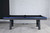 Plank & Hide Co Xander Steel Pool Table, modern black and blue color scheme, situated in a minimalistic room with white brick wall background.