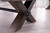 Plank & Hide Co Plank & Hide Voxwood 8' Pool Table, close-up of the dark wood leg with a black metal connector and adjustment bolt, in a modern indoor setting with light flooring and large windows.