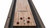 Plank & Hide Co Beaumont Shuffleboard Table by Plank & Hide, a wooden game table with scorekeeping mechanism, featuring smooth finish and storage for pucks, perfect for indoor recreational activities.