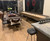 Plank & Hide Co Isaac Shuffleboard Table, a modern wooden shuffleboard table placed in a cozy living room with decorative wreaths on the window.