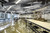 Venture Shuffleboard Mason Sport Shuffleboard Table by Venture, modern entertainment lounge with shuffleboard table, seating, and contemporary design.