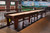 Venture Shuffleboard Chicago Shuffleboard Table by Venture, wooden shuffleboard table with a long, smooth playing surface in an indoor entertainment venue.