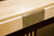 Venture Shuffleboard Chicago Shuffleboard Table by Venture, close-up of the wooden shuffleboard surface with a metal corner bracket.