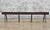 Venture Shuffleboard Williamsburg Shuffleboard Table, dining top option, made in USA, with dark wood finish and black metal legs, against a brick wall background.