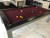 Playcraft Monaco Slate Pool Table & Dining Top – Gloss Black on Silver, a stylish pool table with a burgundy felt surface, black sides, and silver legs in a modern living room setting.