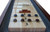 Playcraft Charles River Chestnut Pro-Style Shuffleboard Table, a wooden shuffleboard game with pucks and scoring zones on a polished surface.