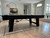 Plank & Hide Co Isaac Pool Table Distressed Black & Gold, black and gold finished pool table in modern living room with natural light.