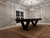 Doc & Holliday Savant 8' Slate Pool Table, brown sugar finish, in a modern game room with a geometric pendant light and a patterned rug.
