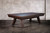 Doc & Holliday George Slate Pool Table in Antique Coffee, wooden pool table with a slate playing surface, modern design, against a brick wall background.