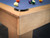 Close-up view of the Paula Parsons pool table’s parsons-style corner joinery, featuring natural maple wood grain and precision-built craftsmanship by Doc & Holliday. Close-up view of the Paula Parsons pool table’s parsons-style corner joinery, featuring natural maple wood grain and precision-built craftsmanship by Doc & Holliday.