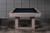 Doc & Holliday Bowie Pool Table in Glazed Pearl, with sleek wooden finish and black playing surface, in a modern room setting.