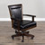 Close-up of Henry dining and game chair with swivel caster base and faux leather padded seat, shown with dark mahogany accents Close-up of Henry dining and game chair with swivel caster base and faux leather padded seat, shown with dark mahogany accents