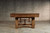 Doc & Holliday Churchill Slate Pool Table with Dining Top Option, wooden pool table on a concrete floor with a textured concrete wall in the background.