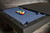 Doc & Holliday Zurich Pool Table by Doc & Holliday, black with custom finishes, pool balls arranged on blue felt surface.