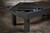 Doc & Holliday Zurich Pool Table, Dining Top Option, black finish, with accessory ramp and wooden top, set in an industrial-style room.