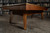 Doc & Holliday Scholar Pool Table by Doc & Holliday, a classic wooden pool table with a sleek design and a polished finish, set against a background of a bookshelves filled with books.