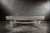 Doc & Holliday Churchill Slate Pool Table, made in USA, featuring a rustic grey wooden finish and sturdy wooden legs in a minimalist design against a textured concrete wall.