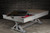 Doc & Holliday Hepburn Slate Pool Table, a professional billiards table with a sleek slate surface and wooden frame in a modern industrial setting.