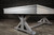 Doc & Holliday Hepburn Pool Table, modern wooden pool table with a sleek and minimalist design, positioned against a black brick wall for an elegant gaming space.
