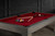 Doc & Holliday The Natural Slate Pool Table, featuring a red felt surface, pool balls arranged in a triangle, and pool cues resting on the table, made in USA.