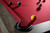 Doc & Holliday The Natural Slate Pool Table, close-up view of pool balls on red felt surface with dark wood border and black corner cushion.