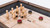 Plank & Hide Co Isaac Pool Table & Shuffleboard Combo, wooden shuffleboard disc and wooden puck game on a multi-game table surface with digital scorekeeping.