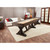 Playcraft Brazos River Pool Table | Playcraft Black | Sawyer Twain, wooden pool table in a modern living room setting with hardwood floors, situated opposite a white sofa with decorative pillows, near glass-paneled doors and contemporary decor.
