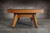 Doc & Holliday Scholar Slate Pool Table, wooden pool table with a natural finish on a concrete floor with a concrete wall background.