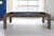Brunswick Billiards Brunswick Soho Slate Pool Table, modern wooden pool table with felt surface, pool balls arranged, cue stick, in a bright room with large windows.