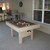 Sawyer Twain Outdoor Bumper Pool Table, photograph of a modern bumper pool table with beige frame and dark playing surface set up in a sunlit indoor space.