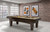 Brunswick Billiards Brunswick Winfield Slate Pool Table, Espresso Finish, with beige felt playing surface in modern game room with brick accent wall and framed artwork.