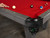 Doc & Holliday Denali Slate Pool Table in Rustic Charcoal, featuring a close-up of the red felt surface, corner pocket with intricate black leather trim, and pool balls arranged on the table.
