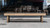 Doc & Holliday Hank Shuffleboard Table, American Chocolate, wooden shuffleboard with a smooth playing surface and sturdy legs, outdoor setting.