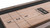 A close-up shot capturing the intricate details of the glazed maple finish and solid maple construction, evoking the warmth and quality of premium craftsmanship.