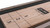 Doc & Holliday Bowie Shuffleboard Table, wooden shuffleboard surface with score markings and branding.