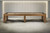 Doc & Holliday Paula Parsons Shuffleboard Table, Glazed Maple, 9 ft & 12 ft, showing a sleek wooden table with a scoring system, situated in a modern minimalist room.