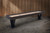 Doc & Holliday Savant Shuffleboard Table by Doc & Holliday, Brown Sugar Finish, stylish elongated shuffleboard table with a sleek wooden finish and black legs, ideal for game rooms.