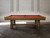 Doc & Holliday Hank Slate Pool Table – Americana Chocolate, a classic pool table with a wooden frame and a red felt surface, positioned in a stylish room with white paneled walls.