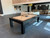 American Heritage Billiards Alta Parsons Slate Pool Table | Black Ash, modern game room with stylish furniture and decor, featuring a sleek black ash finish pool table in an open space.