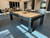 American Heritage Billiards Alta Parsons Slate Pool Table in Black Ash, showing a modern design with a beige playing surface and sturdy black wooden frame in a contemporary living room.