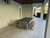 American Heritage Billiards Lanai Outdoor Slate Pool Table in Oyster Grey, outdoor patio setting with neutral-colored tiles and modern design.