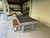 American Heritage Billiards Lanai Outdoor Slate Pool Table in Oyster Grey, outdoor patio with pool table and seating area, modern setting.