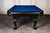 Doc & Holliday Elvira Slate Pool Table, black billiards table with blue felt top, elegant curved legs, and made for recreational and professional pool gaming.