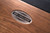 Doc & Holliday Muse Pool Table, made in USA, with a close-up of the brand emblem on the wooden frame showing the craftsmanship and quality of the billiards table.
